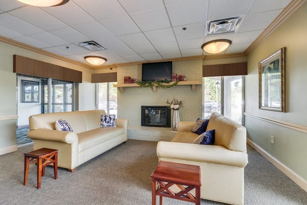 Interior common area with seating and a fireplace