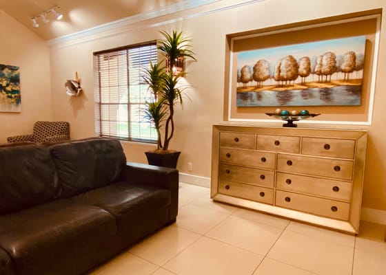 Cozy lounge area with a sofa and wall artwork