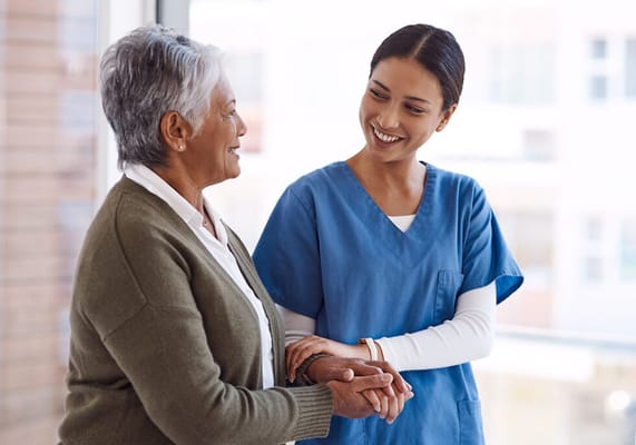 Caregiver interacting with a resident in a bright setting