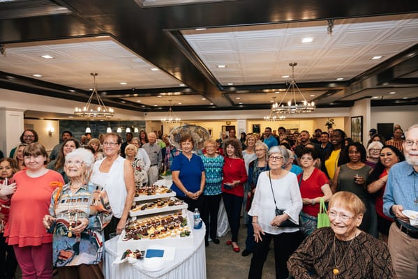 Residents and staff gathered at a community celebration