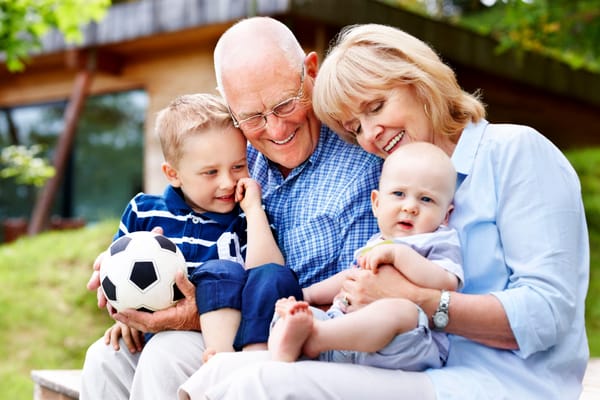 Grandparents with grandchildren in a garden setting