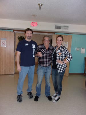 Resident with staff in a common area of the facility
