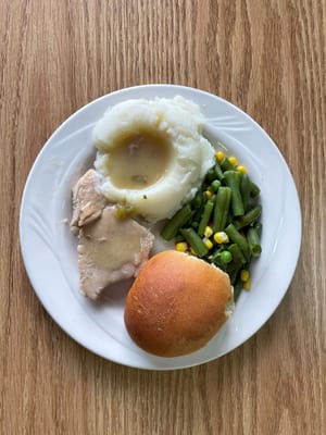 Plate of food with chicken, mashed potatoes, and green beans