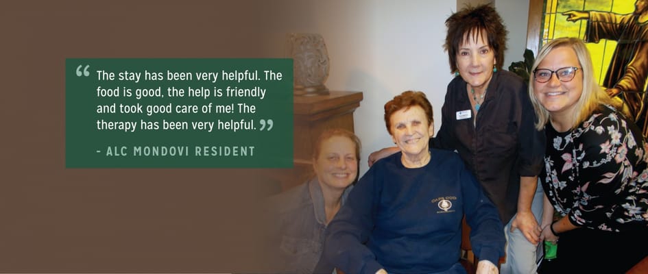 Residents and staff smiling in a cozy common area