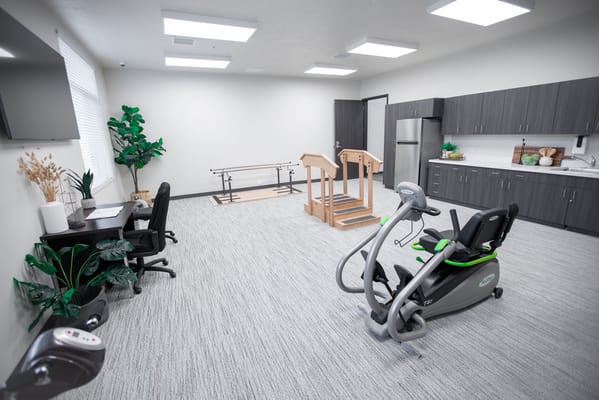 Rehabilitation gym with exercise equipment and therapy steps