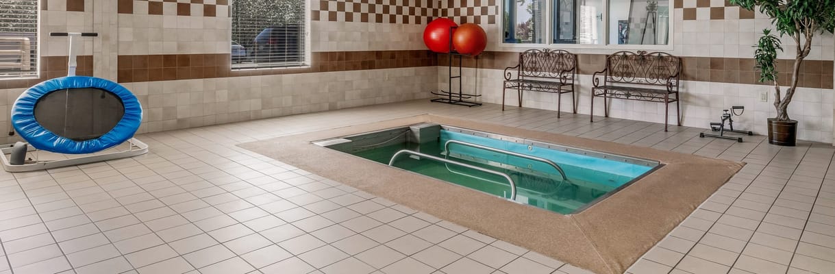 Indoor therapy pool and fitness area with exercise equipment