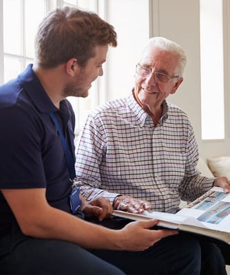 A staff member engaging with a smiling resident