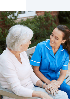 Caregiver interacting with a resident in a garden