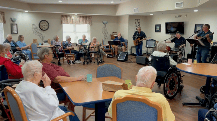 Residents enjoying a live music performance in a common area