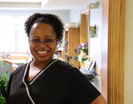 Staff member smiling in a facility interior