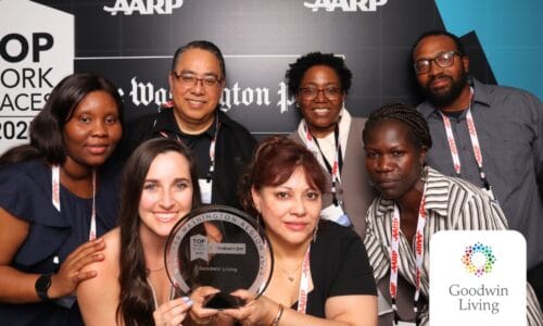Group of staff members celebrating with an award