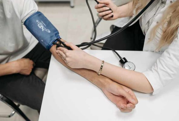 A nurse taking a resident's blood pressure