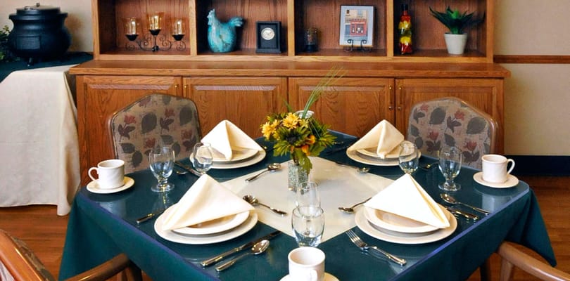 Dining table set for a meal in the communal dining area