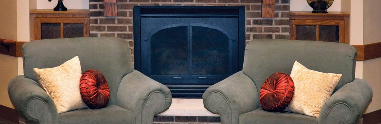 Cozy seating area with soft couches and fireplace