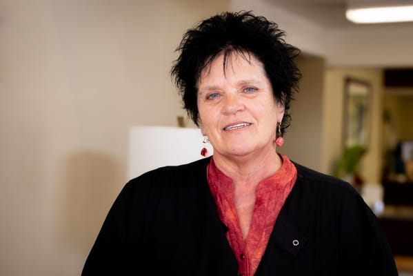 Staff member smiling in a facility interior