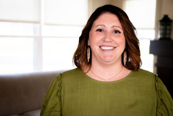 Staff member smiling in a well-lit common area