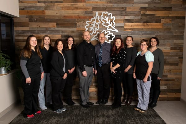 Staff members posing together in a lobby area