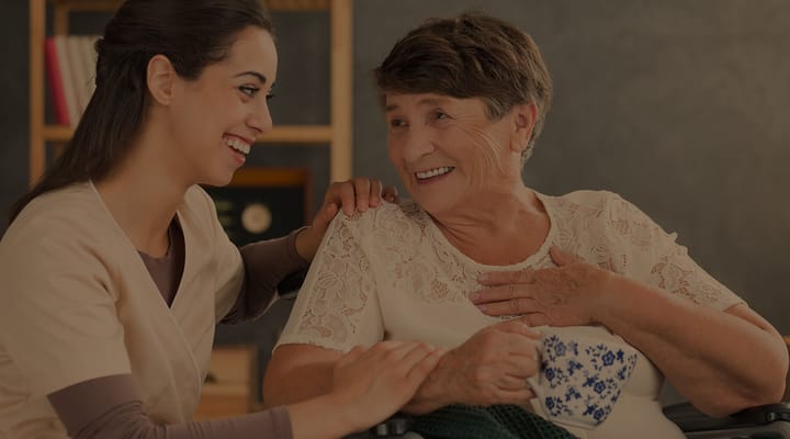 Caregiver interacting joyfully with a senior resident