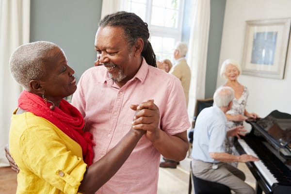 Residents dancing and enjoying music in a communal area