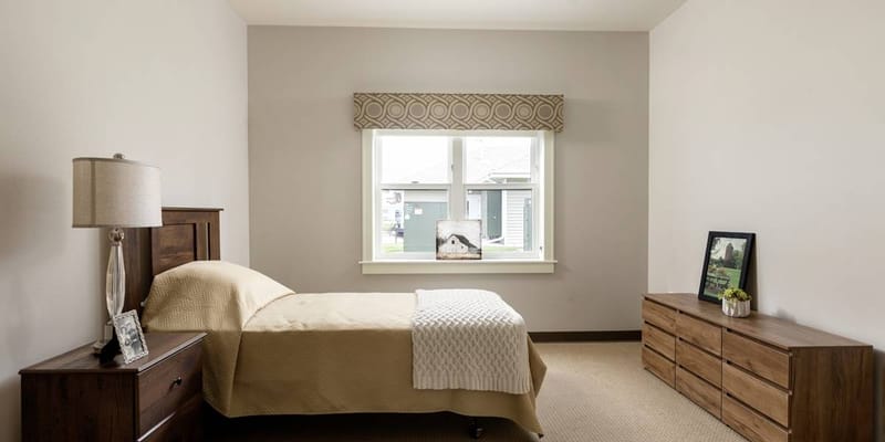 Private resident room with a bed and natural light