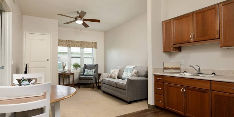 A cozy interior living space with a couch and kitchenette