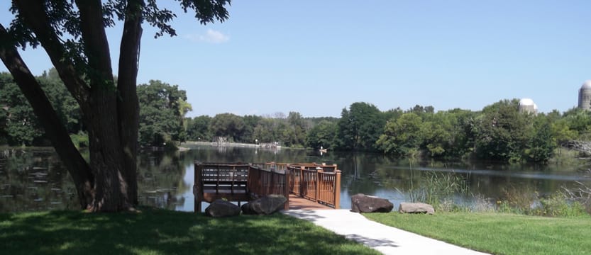Serene view of a dock by a tranquil lake
