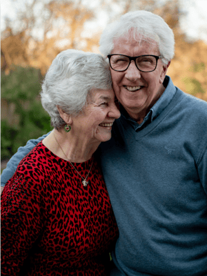 Happy senior couple smiling together outdoors