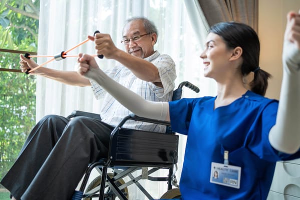 A staff member assisting a resident with exercises