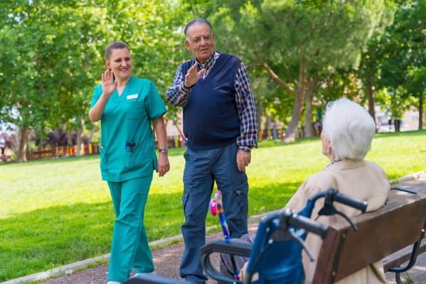 Staff and resident interacting in a garden