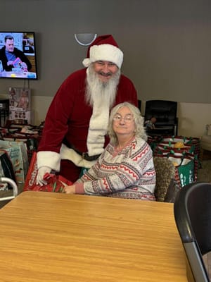 Santa Claus visiting a resident during a festive event