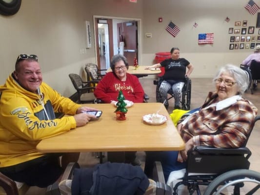 Residents and visitors celebrating at a communal table