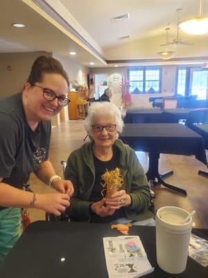 Staff assisting a resident with an activity