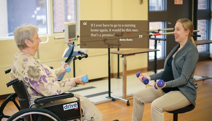 Senior resident and staff member participating in an exercise activity