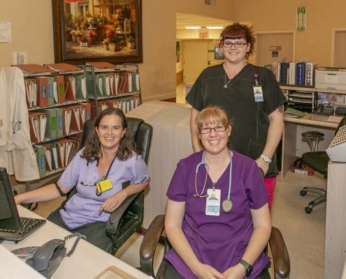 Staff members at the reception area of the facility