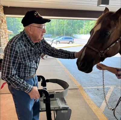 Resident interacting with a horse in a common area
