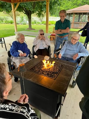 Residents enjoying a group activity around a fire pit