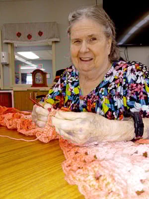 Resident crocheting in a common area
