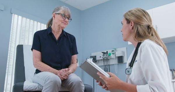 A healthcare professional conversing with a resident