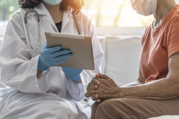 Healthcare professional consulting with a senior resident