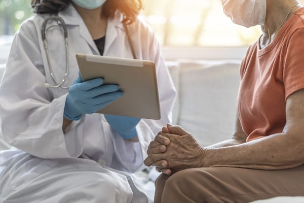 Healthcare professional consulting with a senior resident