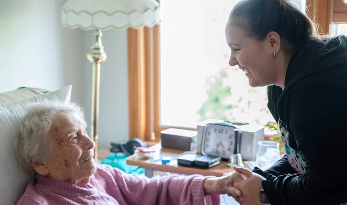 A caregiver interacting warmly with a resident