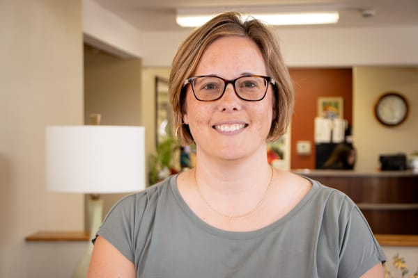 Staff member smiling in a common area