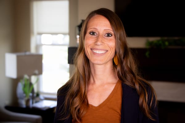 Smiling staff member in a cozy interior space