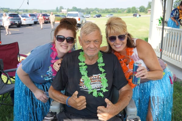 Two women and a man at an outdoor celebration