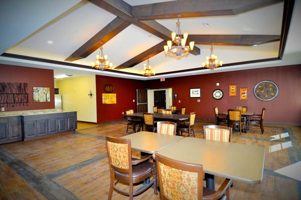 Dining area with tables and chairs in warm tones