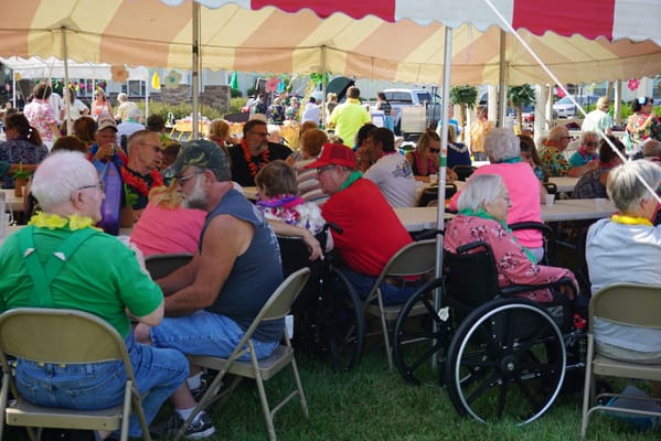 Residents enjoying a festive outdoor gathering at the facility