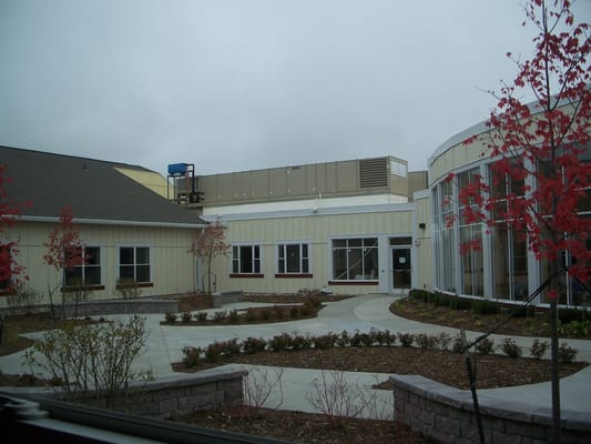 Courtyard with pathways and trees at senior facility