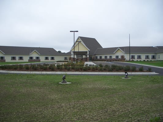 Exterior view of a senior living facility with landscaping