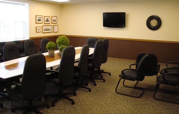 A conference room with chairs around a large table