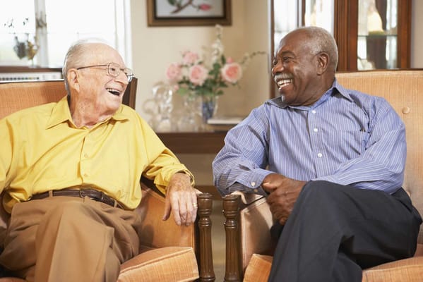 Two residents enjoying a conversation in a common area